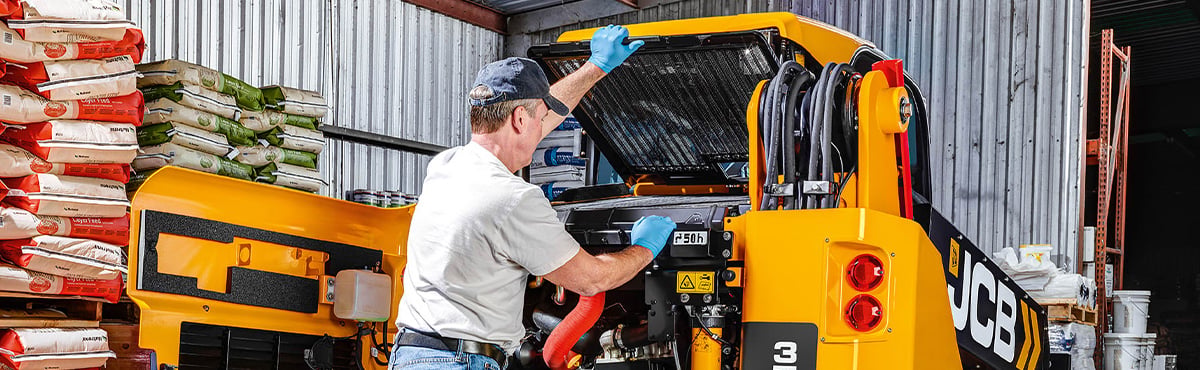 Man working on JCB equipement